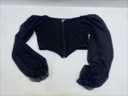 black long-sleeve corset crop top with a front zip closure and sheer ruffled cuffs. black long-sleeve corset crop top with a front zip closure and sheer ruffled cuffs.