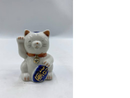 Glass piggy bank in the shape of a Japanese cat