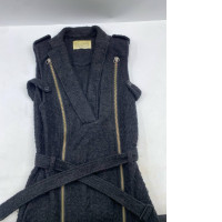 Black bouclé knit sleeveless jacket with brass-tone zippers and a belt Black bouclé knit sleeveless jacket with brass-tone zippers and a belt