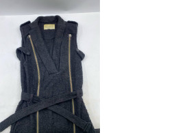 Black bouclé knit sleeveless jacket with brass-tone zippers and a belt