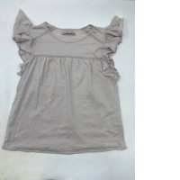 Light pink girl's top with ruffled sleeves and pleated eyelet details.