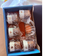 a set of 5 tea cups and saucers