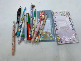 A set of stationery supplies, including: two notepads, two automatic pencils, four red pens, four blue pens, two erasers