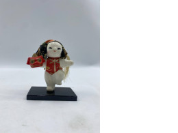 AJapanese Gojo doll depicting a chubby boy performing Shishimai (lion dance).