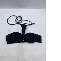 black cross neck tube top with an adjustable snap button closure on the back. 