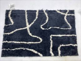 Black doormat with white stripes
