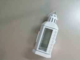 Glass candle holder with metal body