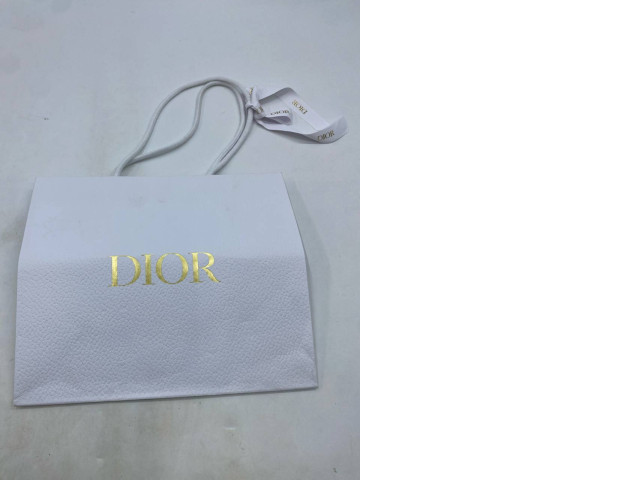 White paper bag, Dior. White paper bag, Dior.