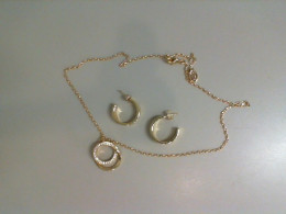 A set of earrings and a necklace with a pendant