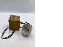 A Japanese matcha green tea cup, served in a traditional wooden box (kiribako).