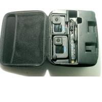 A box containing two GoPro action cameras without batteries, one USB cable and a charger.