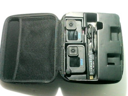 A box containing two GoPro action cameras without batteries, one USB cable and a charger. A box containing two GoPro action cameras without batteries, one USB cable and a charger.