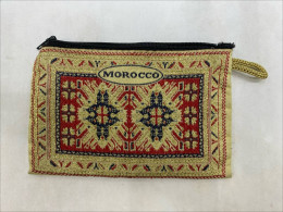 Moroccan-style fabric coin purse with a rug pattern and zipper closure. Moroccan-style fabric coin purse with a rug pattern and zipper closure.
