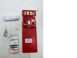 A portable red sewing kit for minor repairs.