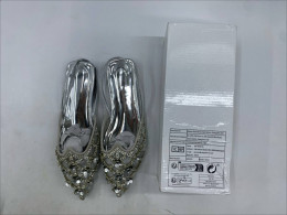 silver rhinestone-embellished ethnic flat shoes, possibly a type of Punjabi jutti or mojari. silver rhinestone-embellished ethnic flat shoes, possibly a type of Punjabi jutti or mojari.