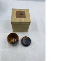 wooden stick with green tea in a wooden box.