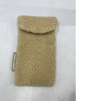 Beige faux sheepskin eyeglass case.