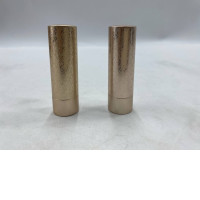 Set of 2  Gucci Rouge à Lèvres Satin lipstick packaged in a gold tube with an etched decorative pattern inspired by Art Deco.  