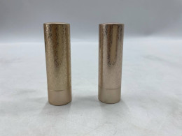 Set of 2  Gucci Rouge à Lèvres Satin lipstick packaged in a gold tube with an etched decorative pattern inspired by Art Deco.  