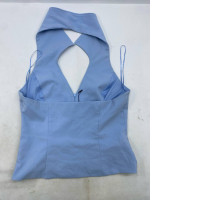 light blue halter neck top with a V-neckline and open back details. light blue halter neck top with a V-neckline and open back details.