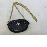 SVNX Bee Embellished Rounded Crossbody Bag in black. 