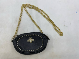 SVNX Bee Embellished Rounded Crossbody Bag in black. 