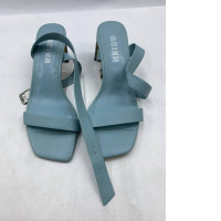  pair of sky blue leather heeled sandals with ankle straps, possibly the "Anna" style from Bloom Paris