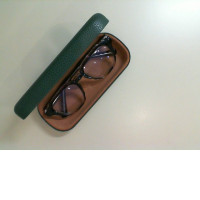 Prescription glasses in a green case Prescription glasses in a green case