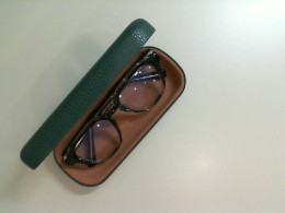 Prescription glasses in a green case Prescription glasses in a green case