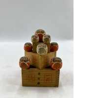 Traditional Japanese Daruma wooden dolls and sake maru cups.