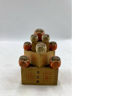 Traditional Japanese Daruma wooden dolls and sake maru cups.