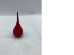 This is a red rubber bulb syringe, a syringe for ear or mouth sores. This is a red rubber bulb syringe, a syringe for ear or mouth sores.