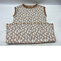 Red sleeveless crew neck shirt with white checkered pattern.