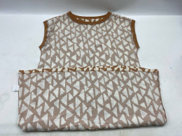 Red sleeveless crew neck shirt with white checkered pattern. Red sleeveless crew neck shirt with white checkered pattern.