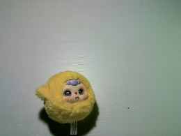 Yellow Labubu toy, crying baby. Yellow Labubu toy, crying baby.
