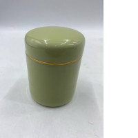 An empty olive green metal tea tin with a gold band.