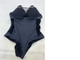 One-piece swimsuit with navy blue and white polka dots.