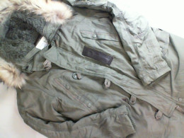 Green jacket with a fur hood