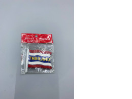 Refrigerator magnet in the shape of the Thai flag.