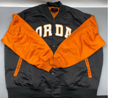 Jordan Brooklyn Collegiate Varsity Jacket in black and orange with a water-repellent shell and satin-stitched details. 