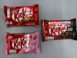 Set of 3 Kit Kat chocolate bars from Nestlé come in classic milk chocolate, pink strawberry, and dark chocolate flavors.