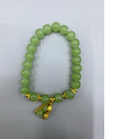 Jade green bracelet with gold charm.