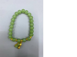 Jade green bracelet with gold charm.