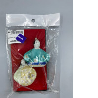 Two small, hand-painted ceramic figurines, possibly in the Arita pottery style.