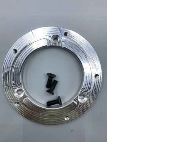 An aluminum mounting plate or adapter, likely for automotive use, could be an adapter ring for a horn button on a steering wheel or a base plate for an ignition switch. An aluminum mounting plate or adapter, likely for automotive use, could be an adapter ring for a horn button on a steering wheel or a base plate for an ignition switch.