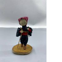 An antique Japanese folk doll, believed to be a depiction of a farm worker.