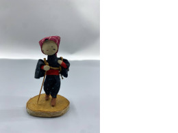 An antique Japanese folk doll, believed to be a depiction of a farm worker.