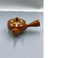 Orange Chinese teapot and cup.