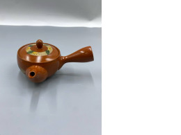 Orange Chinese teapot and cup.