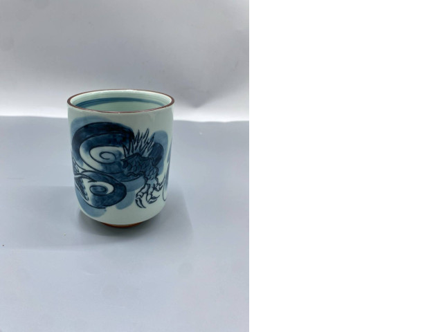 Japanese teacups made from hasami-yaki porcelain, also known as yunomi, feature a cobalt blue dragon (ryu) motif underglaze. Japanese teacups made from hasami-yaki porcelain, also known as yunomi, feature a cobalt blue dragon (ryu) motif underglaze.